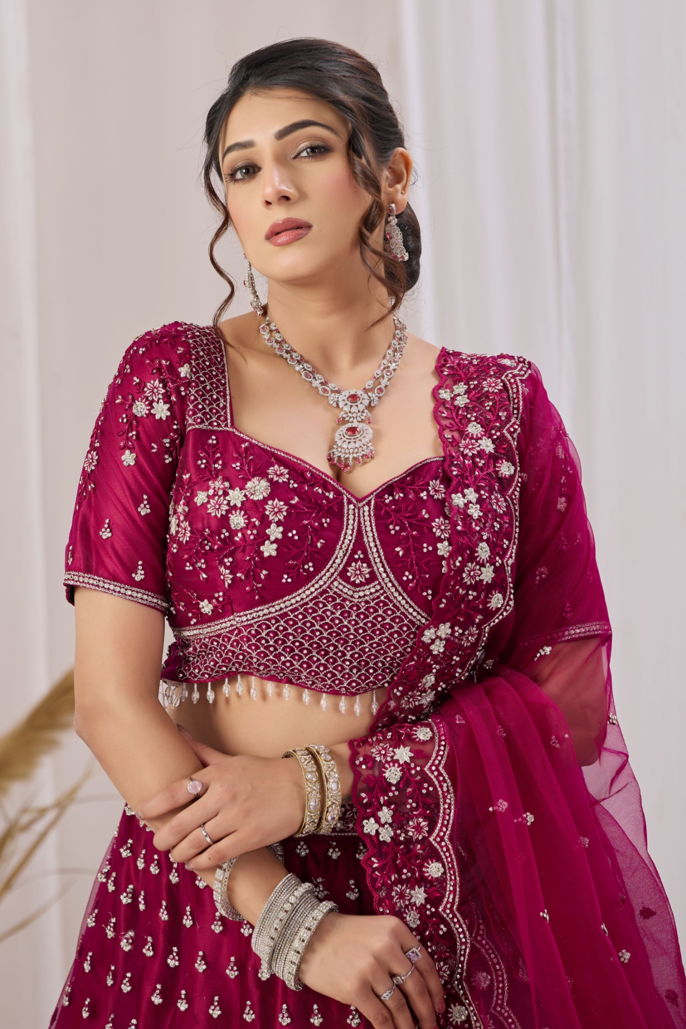 Magenta Ethnic Motif Embroidered Net Lehenga Choli